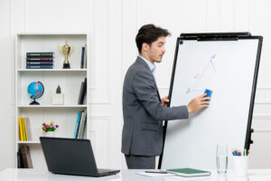 teacher-smart-instructor-grey-suit-classroom-with-computer-whiteboard-erasing-board